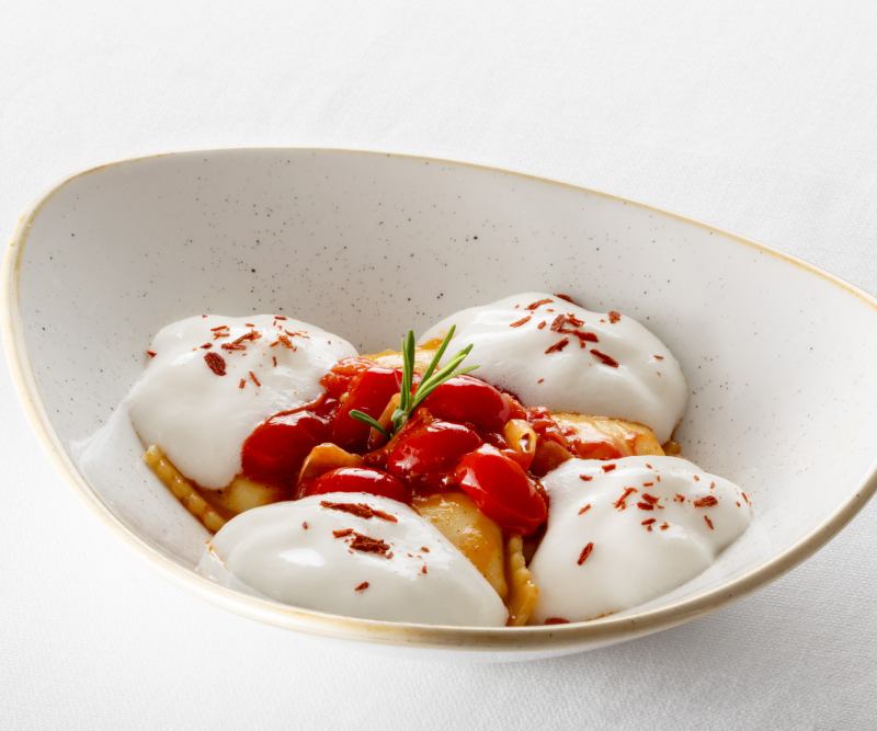 Gourmet Tuscan dish by chef Mirko Vaselli with fresh pasta, cherry tomatoes and refined presentation in a restaurant in Asciano - Castello di Leonina, BZAR hotels in Tuscany
