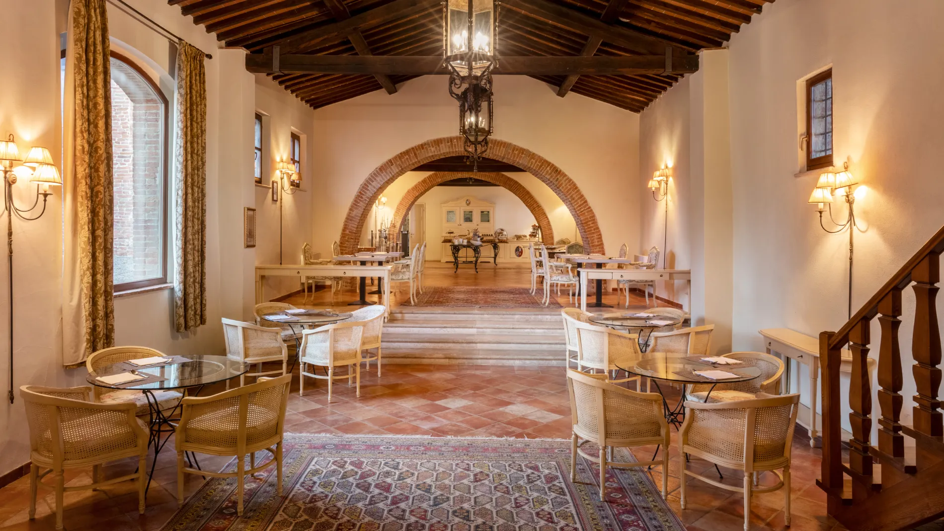 Breakfast room with wooden ceilings, arches and elegant tables in a refined setting in the heart of Tuscany - Castello di Leonina, BZAR hotels in Tuscany