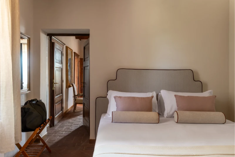 Camera da letto della Villa Annex Adults Only con testata imbottita e corridoio in cotto, a 5 minuti dal Castello di Leonina - Castello di Leonina, BZAR hotels in Toscana
